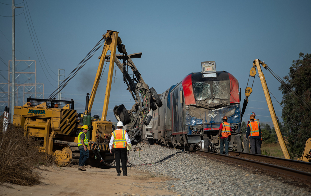 Equipment lifts wreckage from front of damaged locomotive