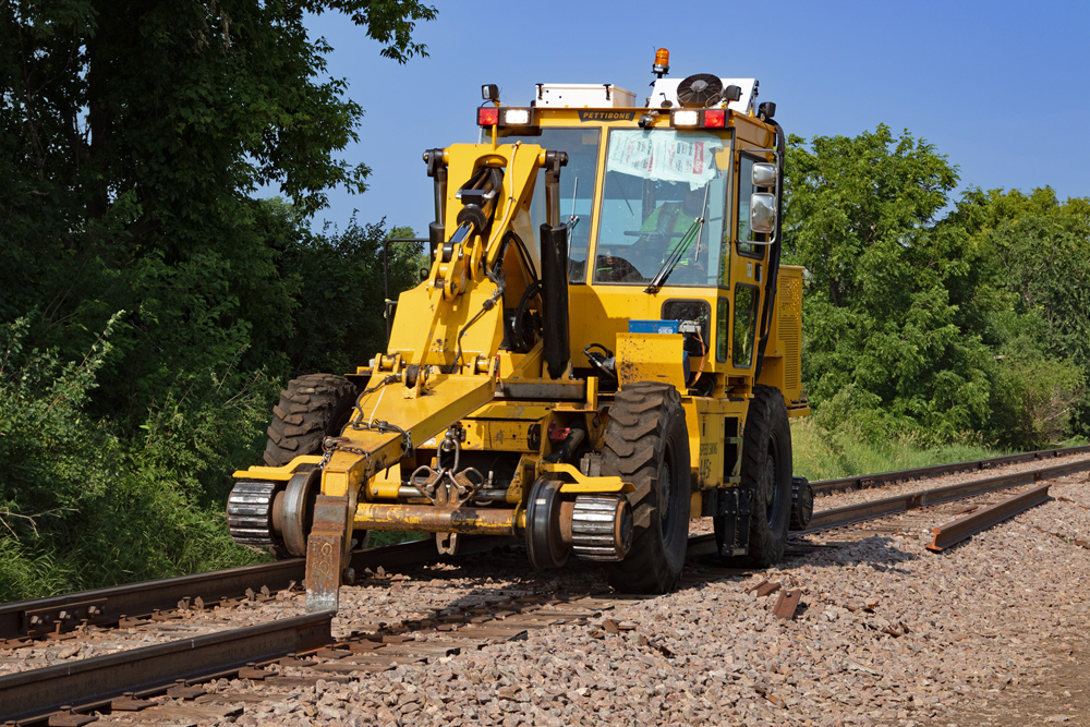 Yellow tractor moves rail to fill gap