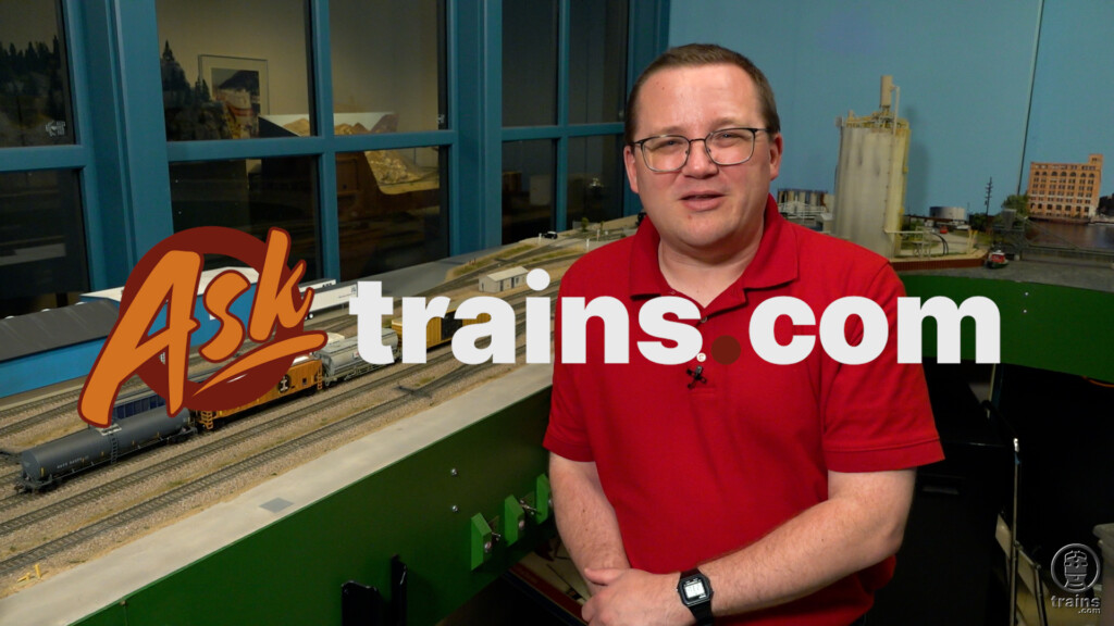 Ask Trains.com July compilation part one: An image of a man standing alongside a model railroad layout