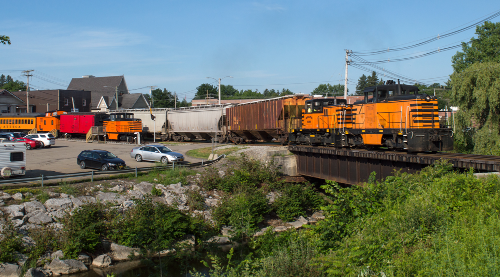 Two orange and black center-cab diesels on excursion train