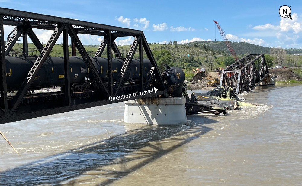Photo of damaged bridge and tank cars in river
