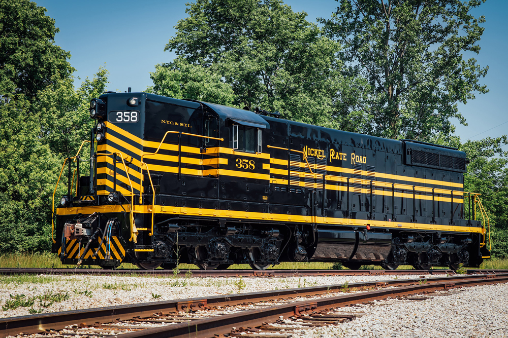 Black six-axle diesel with high short hood and elaborate gold striping