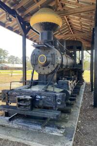 Steam locomotive numbered 7 underneath a canopy