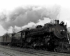 Smoking Georgia Railroad steam locomotive with passenger train