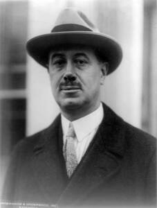 Man wearing hat and tie