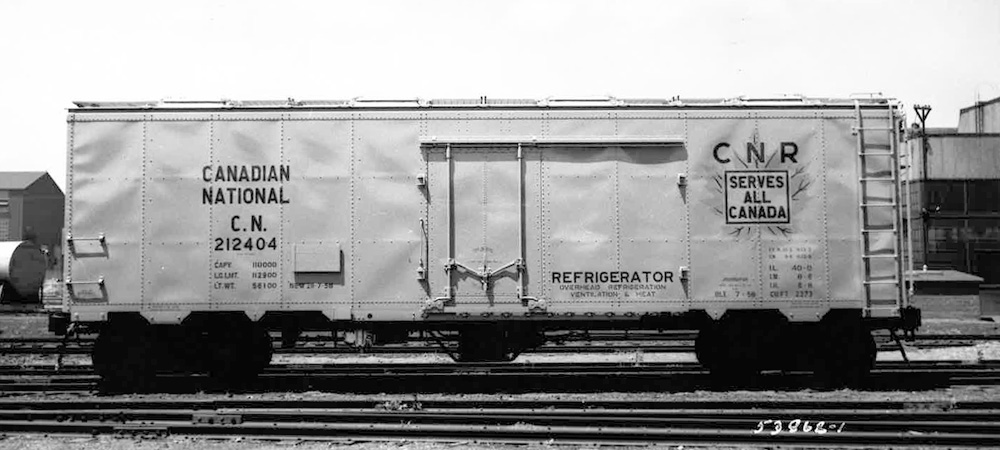 A black-and-white builder’s photo of a steel-sided overhead bunker reefer car