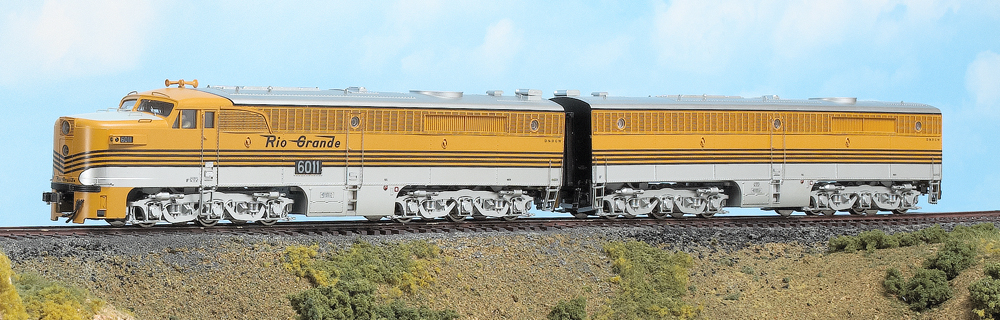 Color photo of two streamlined HO scale diesels on scenic base.