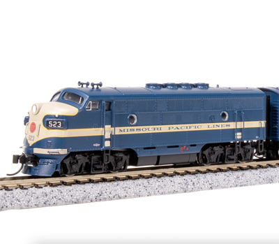 A blue model locomotive against a white background