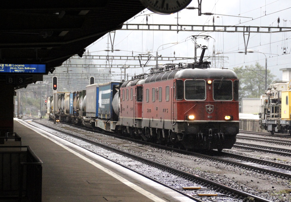 Swiss freight train with two red boxcab electric locomotives