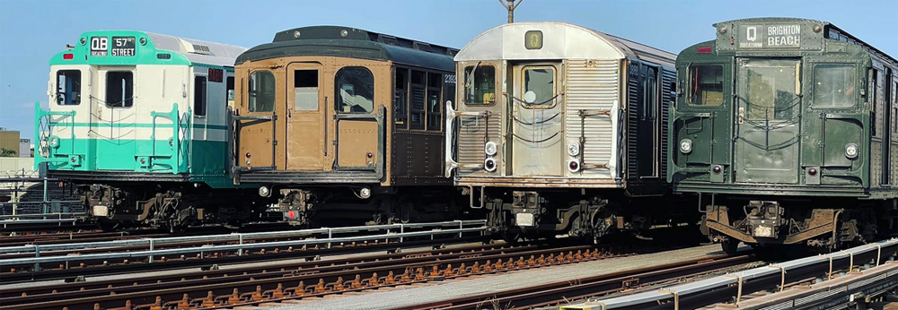 Four types of vintage subway cars lined up on adjacent tracks