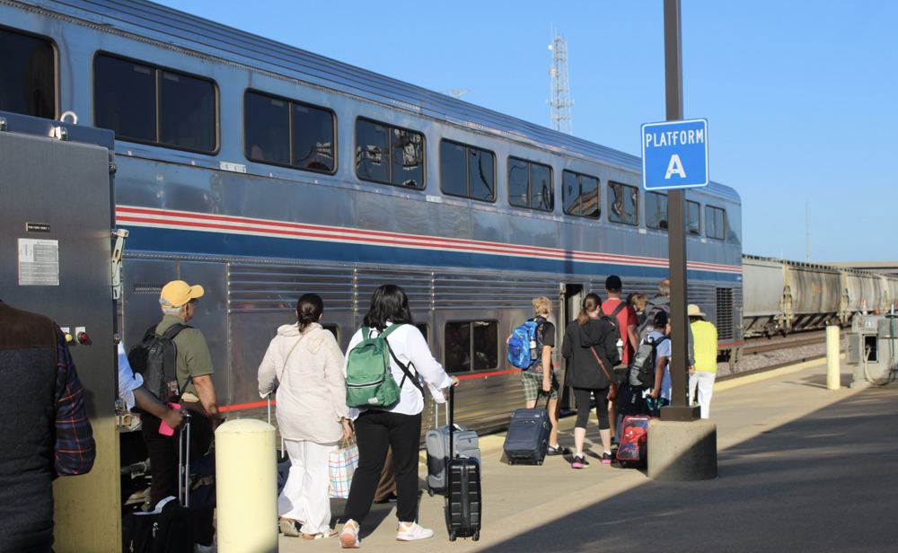Passengers lined up to board car at station