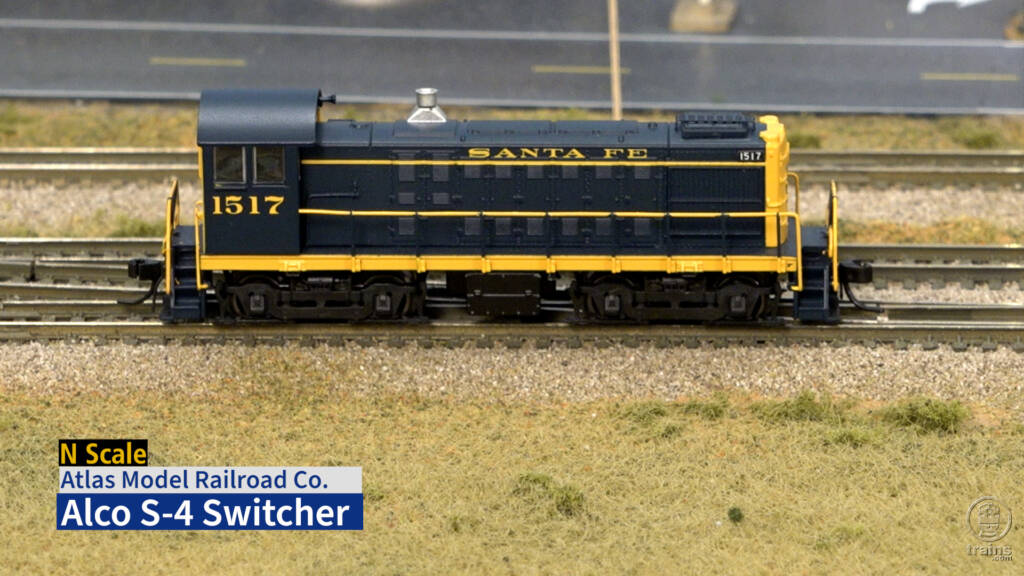 Screen capture from video with N scale locomotive in blue and yellow paint.