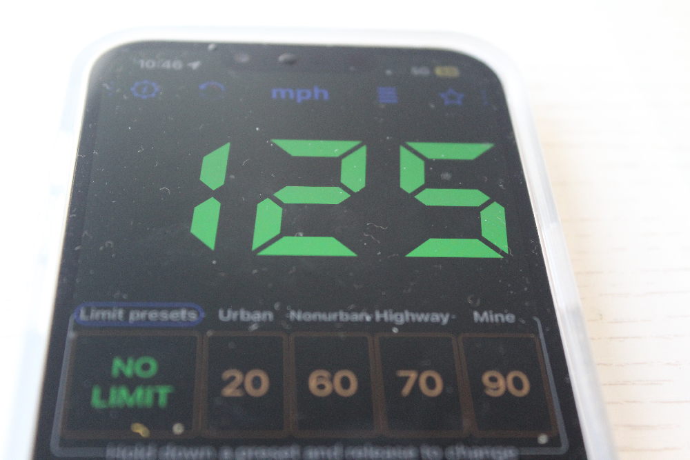 iPhone screen showing digital speedometer reading of 125 mph.