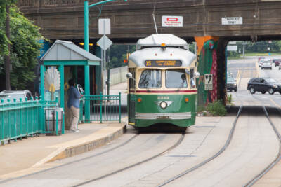 Cream, green and maroon PCC trolley car running in street. PCC cars return to the streets of Philadelphia.