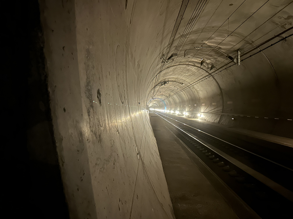 Interior of concrete tube of rail tunnel with one track