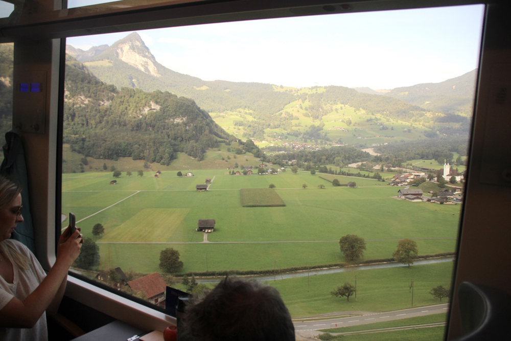 View of mountain and valley through large train window