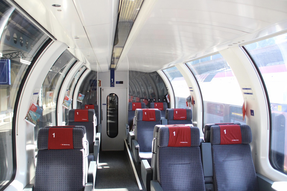 Interior of passenger car with curved glass windows