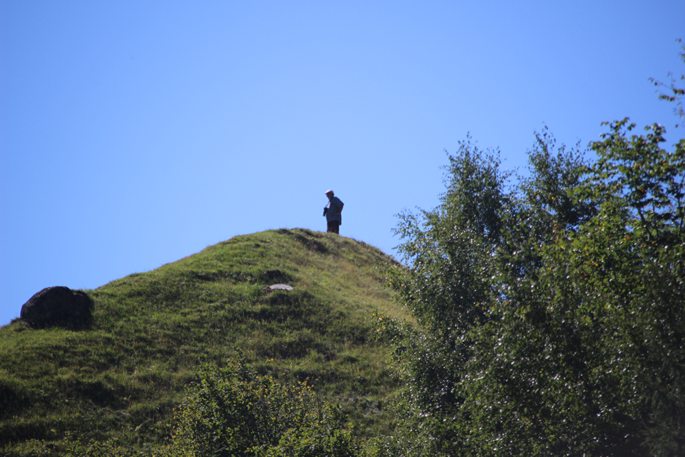 Man standing on top of hill
