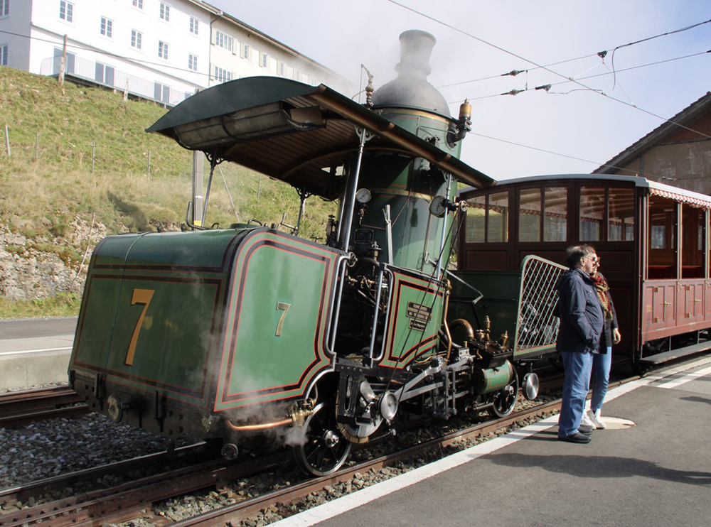 Green steam locomotive with upright boiler