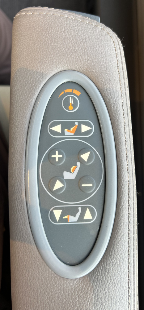 Close-up of seat controls on armrest.