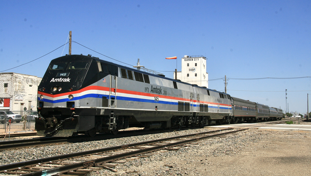 Short Amtrak special train with grain elevator in background