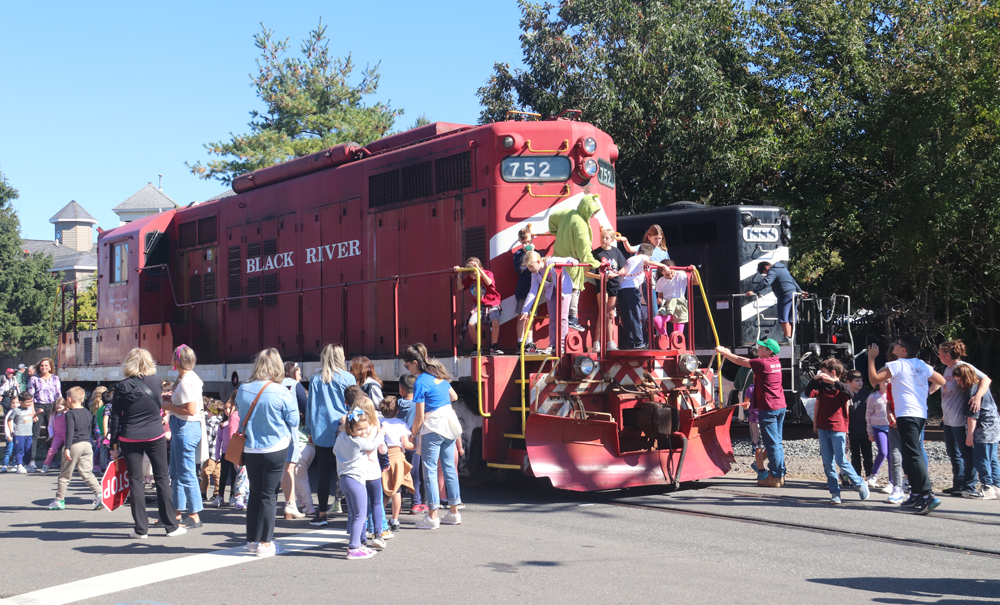 Children climbing on red locomotive