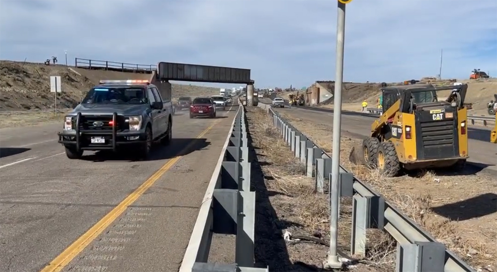 Cars moving on highway past site of railroad overpass