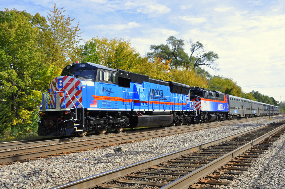 Blue locomotive with orange stripe on commuter train