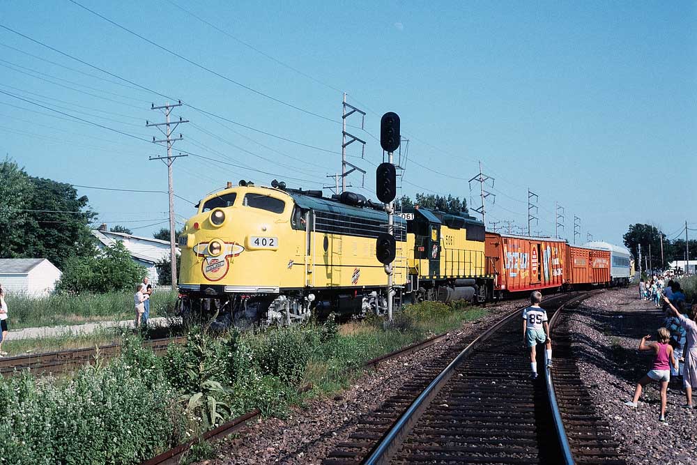 Streamlined Chicago & North Western locomotives with circus train passing signals