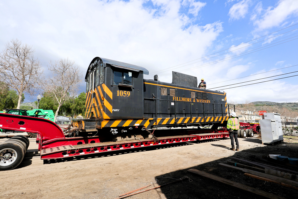 black and yellow locomotive on red truck