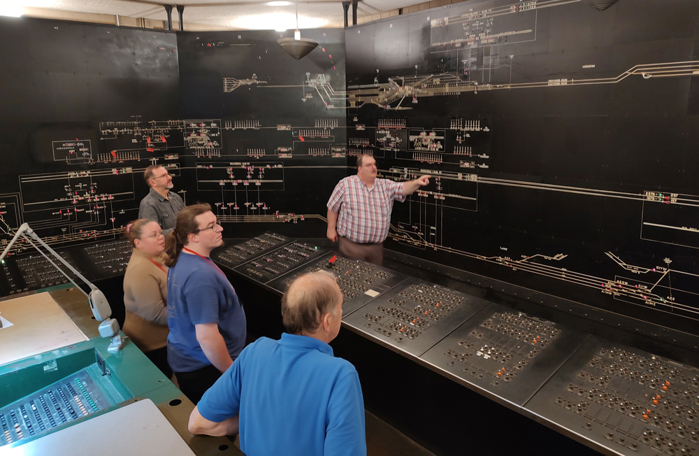 Group visits room with dispatching-center-like track displays