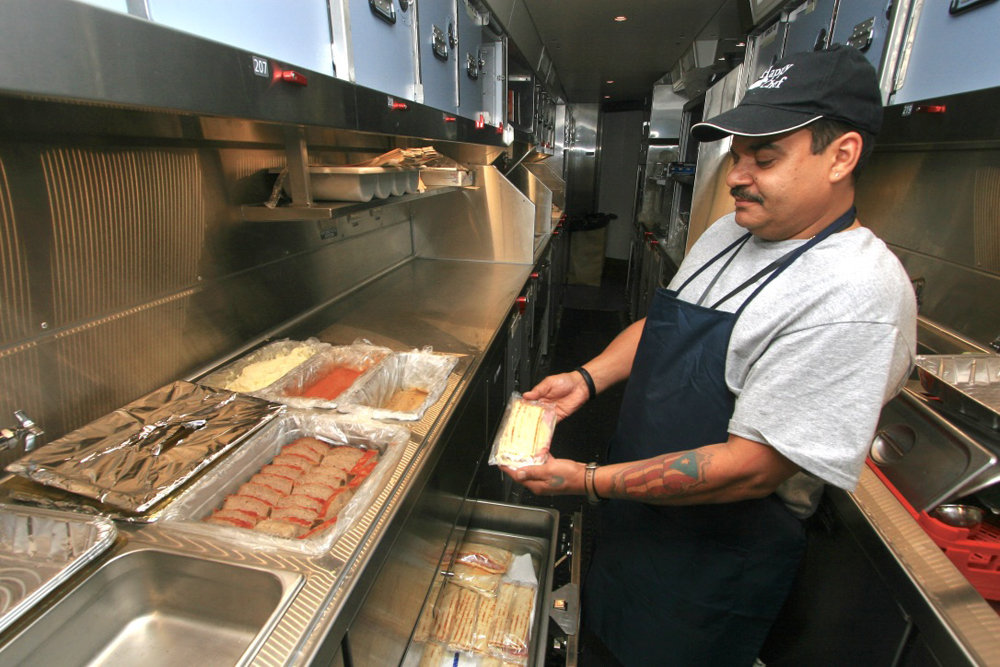 Man working in kitchen of dining car