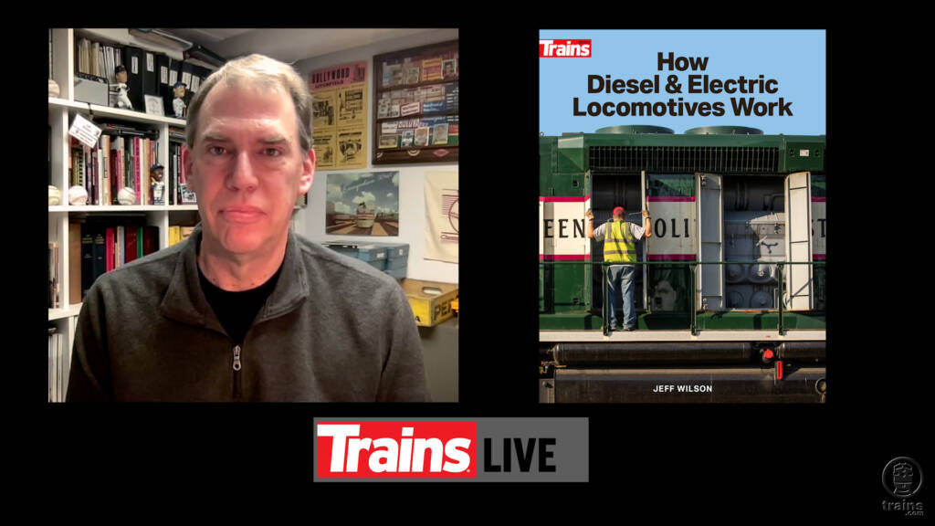 A man next to the image of a book cover. Trains LIVE — 'How Diesel & Electric Locomotives Work'