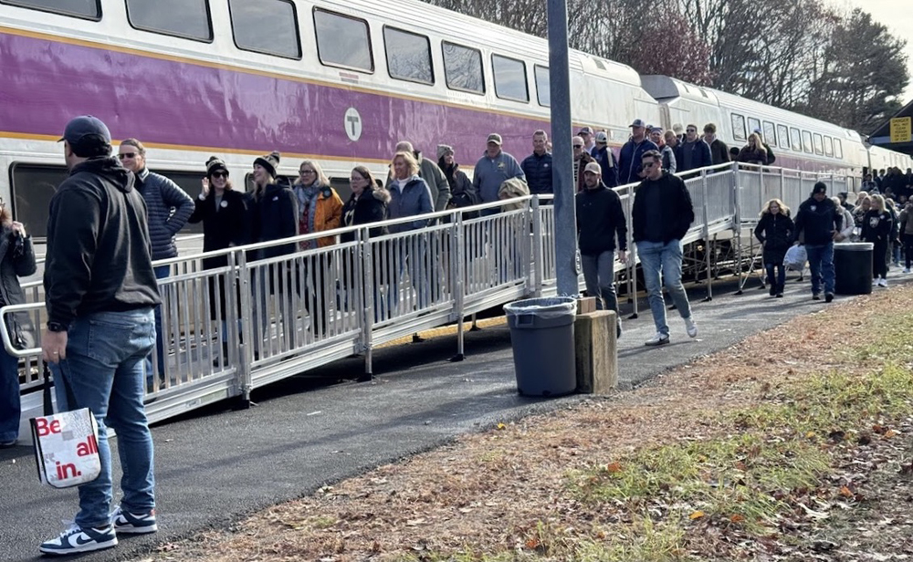 Passengers use portable platform to exit commuter train