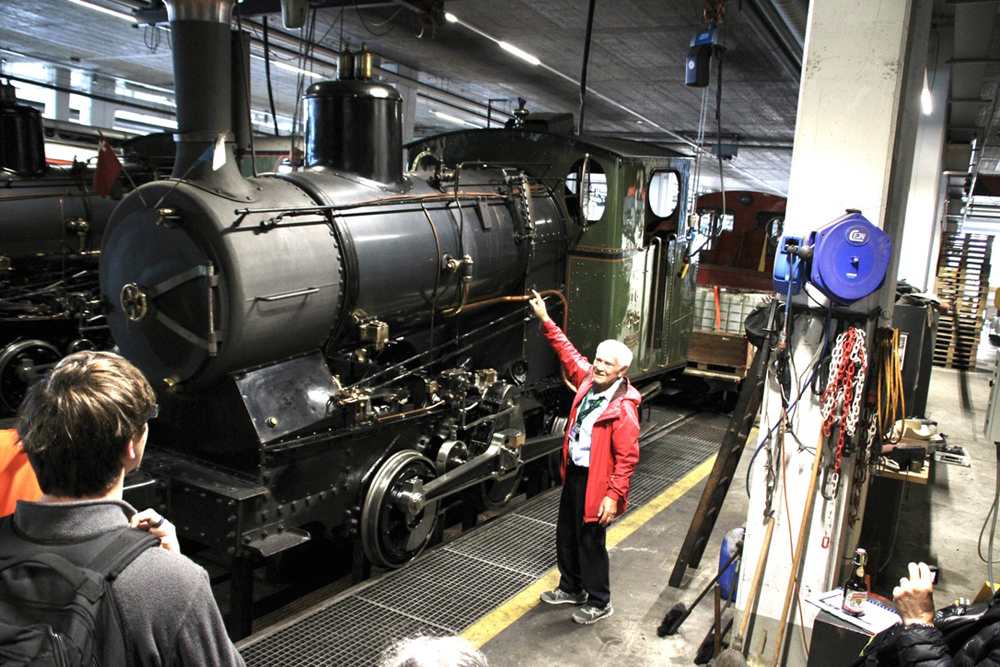 Man gesturing to steam locomotive