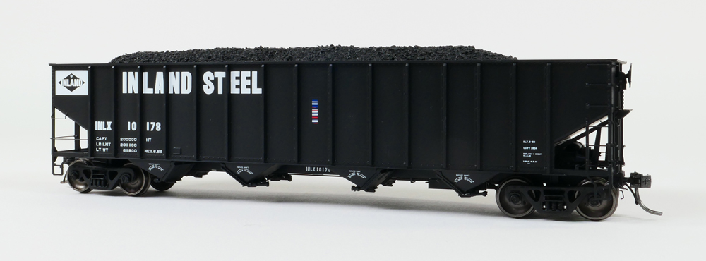 Color photo of HO scale four-bay hopper painted black with white graphics.