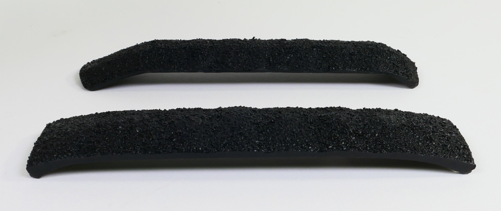 Color photo of two HO scale plastic coal loads.