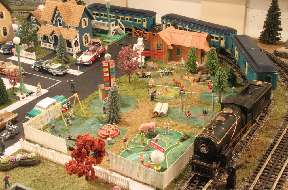 train and passenger cars on toy train layout