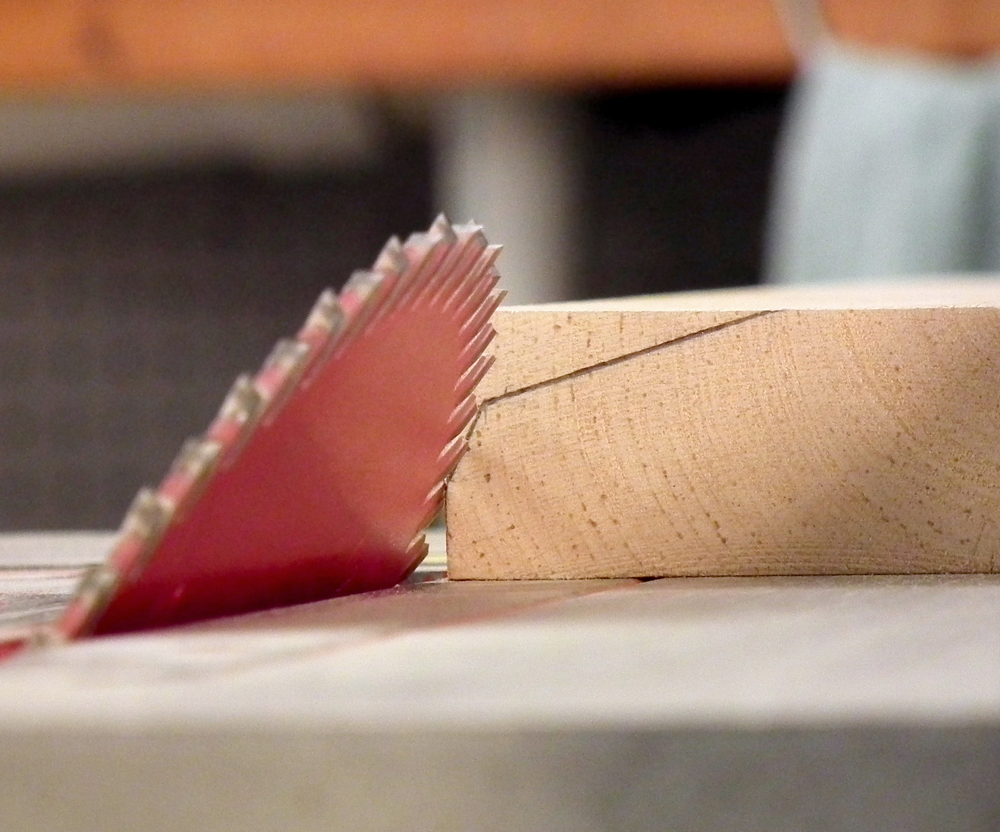 table saw cutting a piece of wood