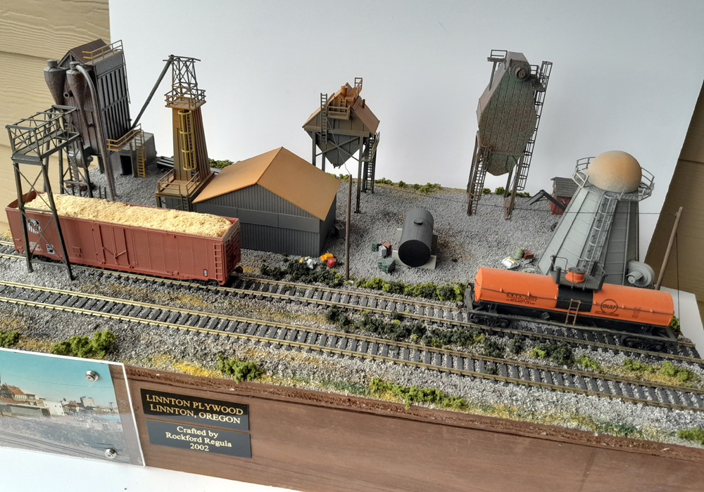 An HO scale diorama of a plywood mill with multiple buildings