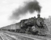 Smoking steam locomotive with passenger train