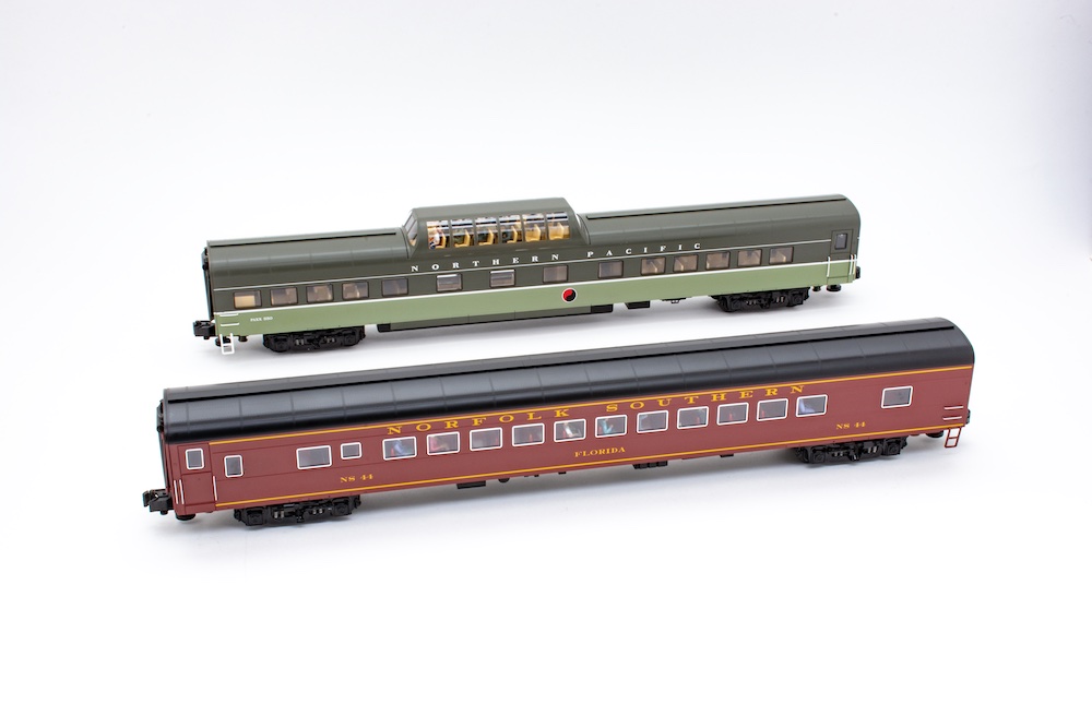 Coach and dome car next to each other with seated figures inside, show the results of installing figures in Lionel's 21" passenger cars