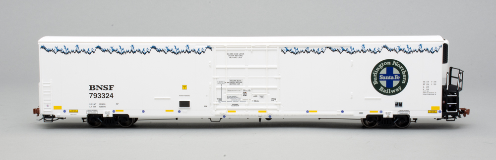 Side view of HO scale freight car painted white with multi-color graphics.