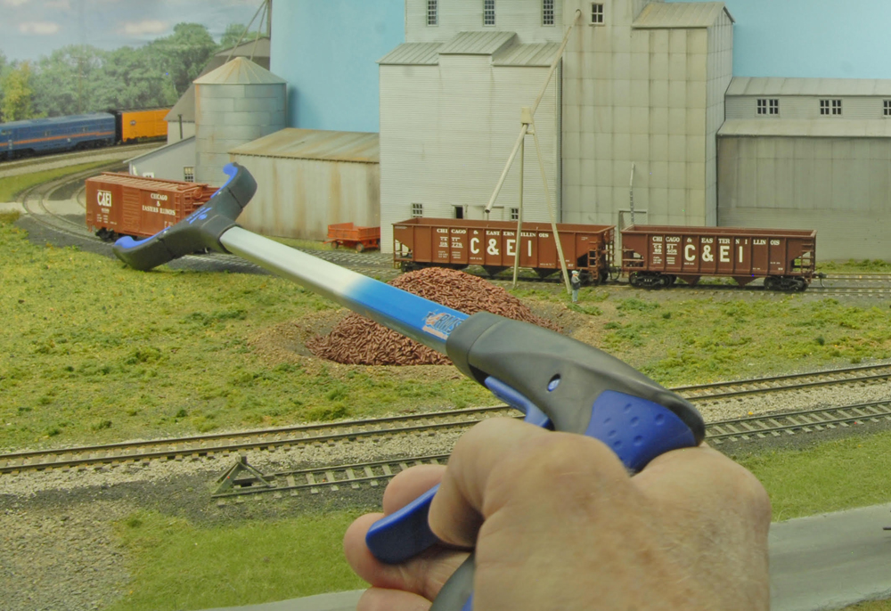 Color photo of reach extender being used on a model railroad