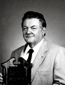 Black and white photo of a man with a camera