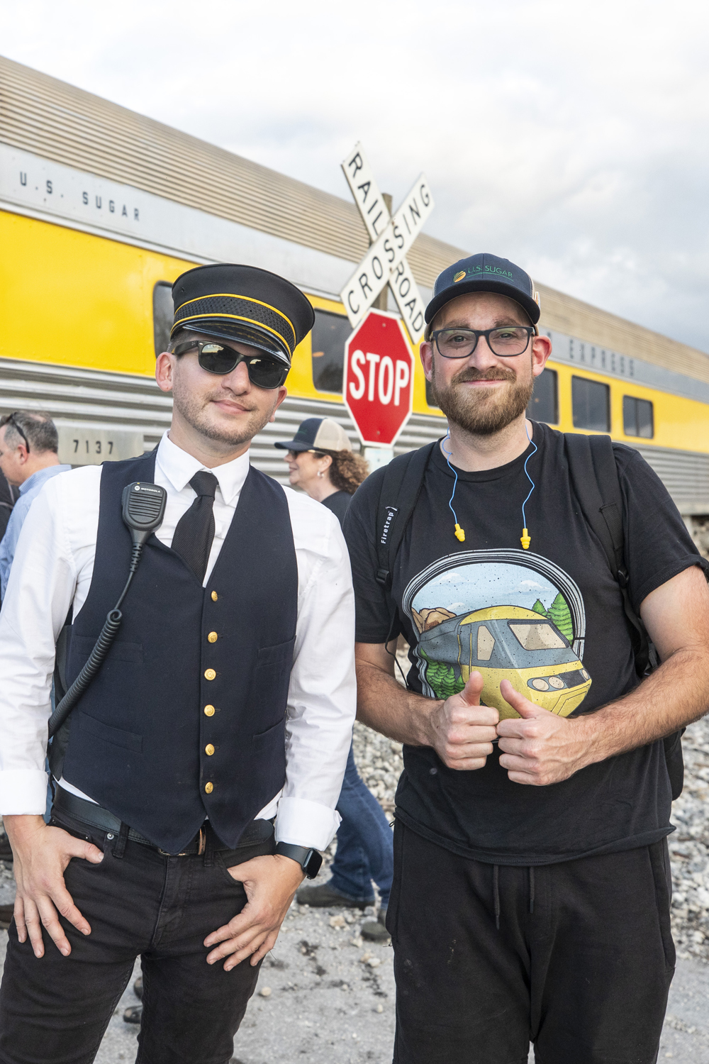 man dressed as conductor standing with another man