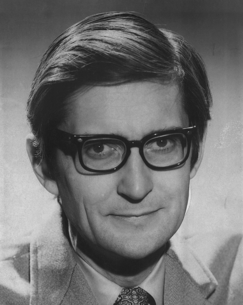 Black-and-white 1970s head shot of man with glasses