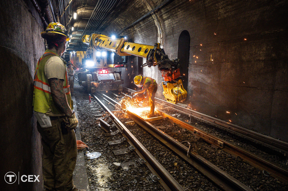 Track crew works in transit tunnel
