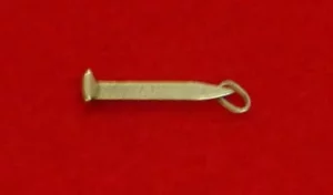 Small gold watch fob on a red background