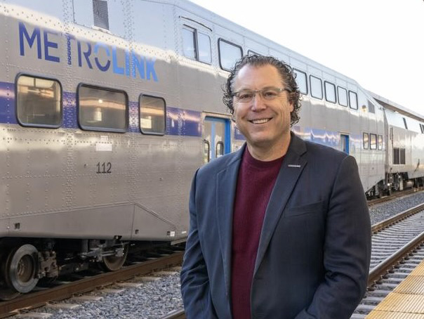 Man in front of commuter railcar